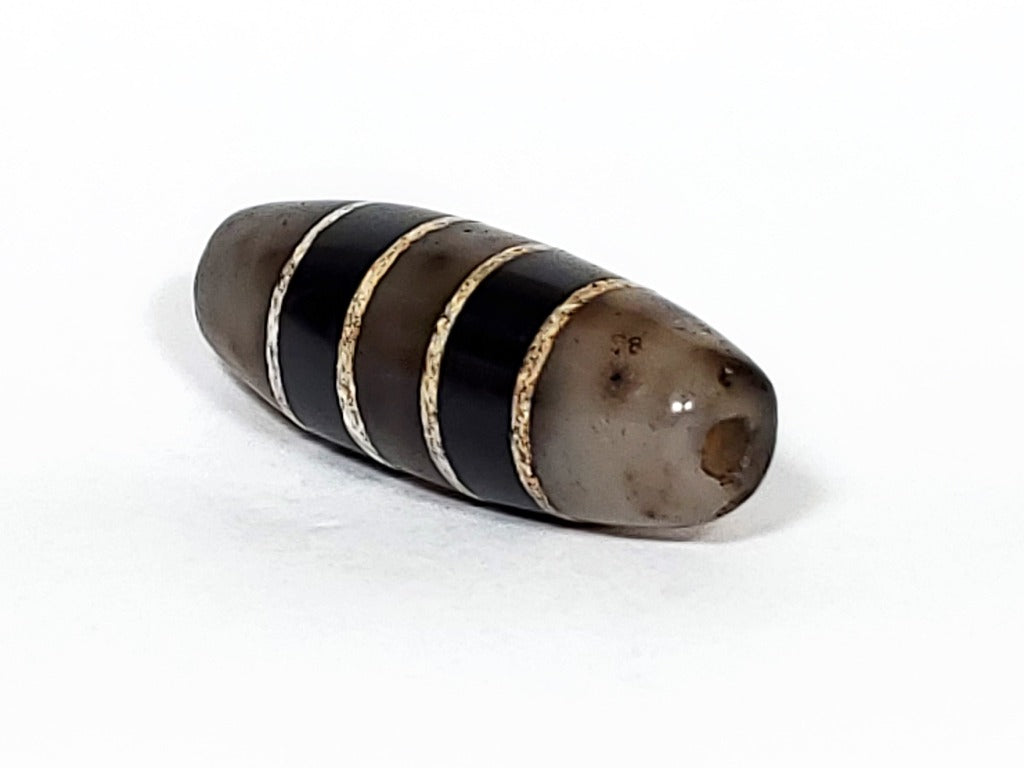 Antique Seven Stripe Dzi Bead" Description: "Authentic antique Seven Stripe Dzi bead with a gorgeous color combination. This exquisite artifact showcases its seven stripes and unique beauty