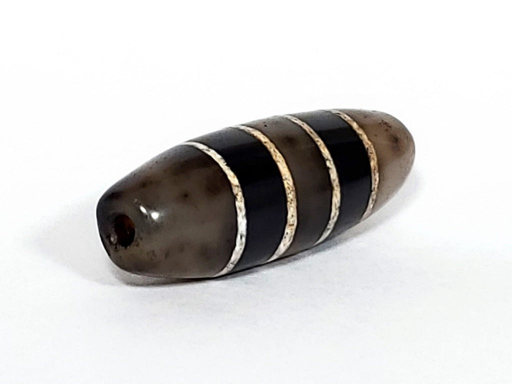 Antique Seven Stripe Dzi Bead" Description: "Authentic antique Seven Stripe Dzi bead with a gorgeous color combination. This exquisite artifact showcases its seven stripes and unique beauty