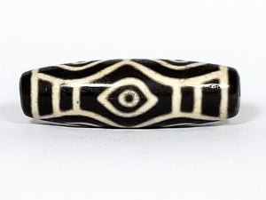 Vintage Dragon Eye Dzi Bead" Description: "A mesmerizing vintage Dzi bead featuring a captivating dragon eye motif. The intricate details and vibrant colors of the bead create an aura of mystique and power