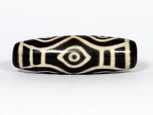 Vintage Dragon Eye Dzi Bead" Description: "A mesmerizing vintage Dzi bead featuring a captivating dragon eye motif. The intricate details and vibrant colors of the bead create an aura of mystique and power