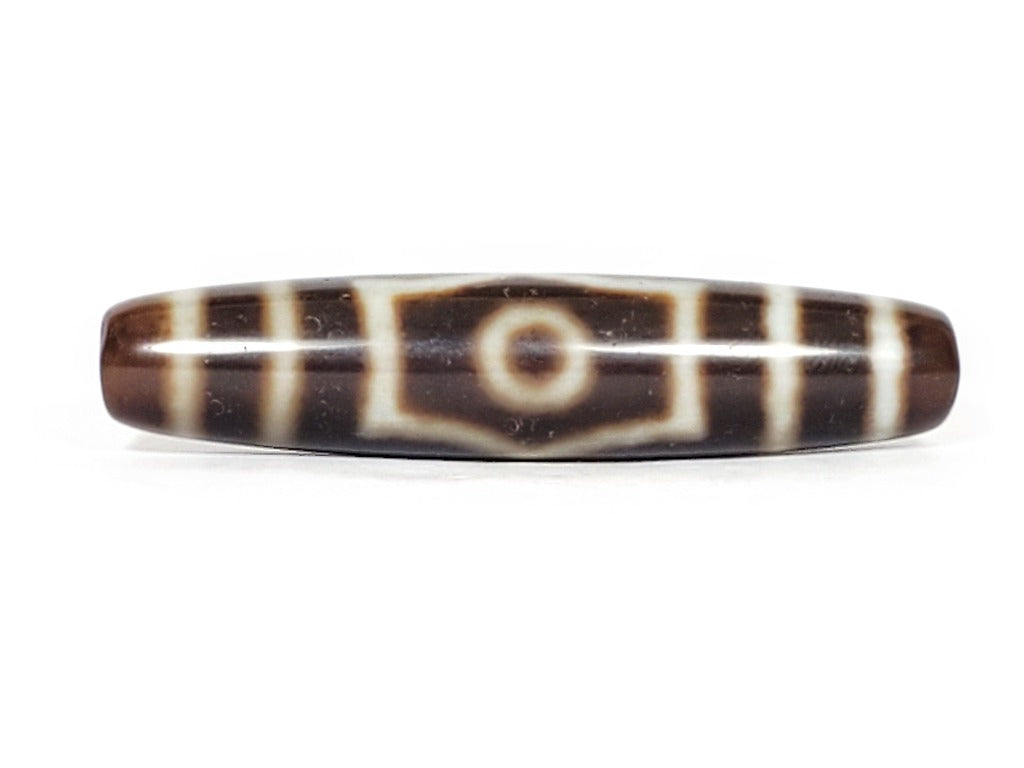 A vintage Dzi bead with a mesmerizing Three Eye Motif. This authentic artifact, identified as TD-ThE-003, showcases the intricate craftsmanship and spiritual symbolism of ancient Dzi beads.