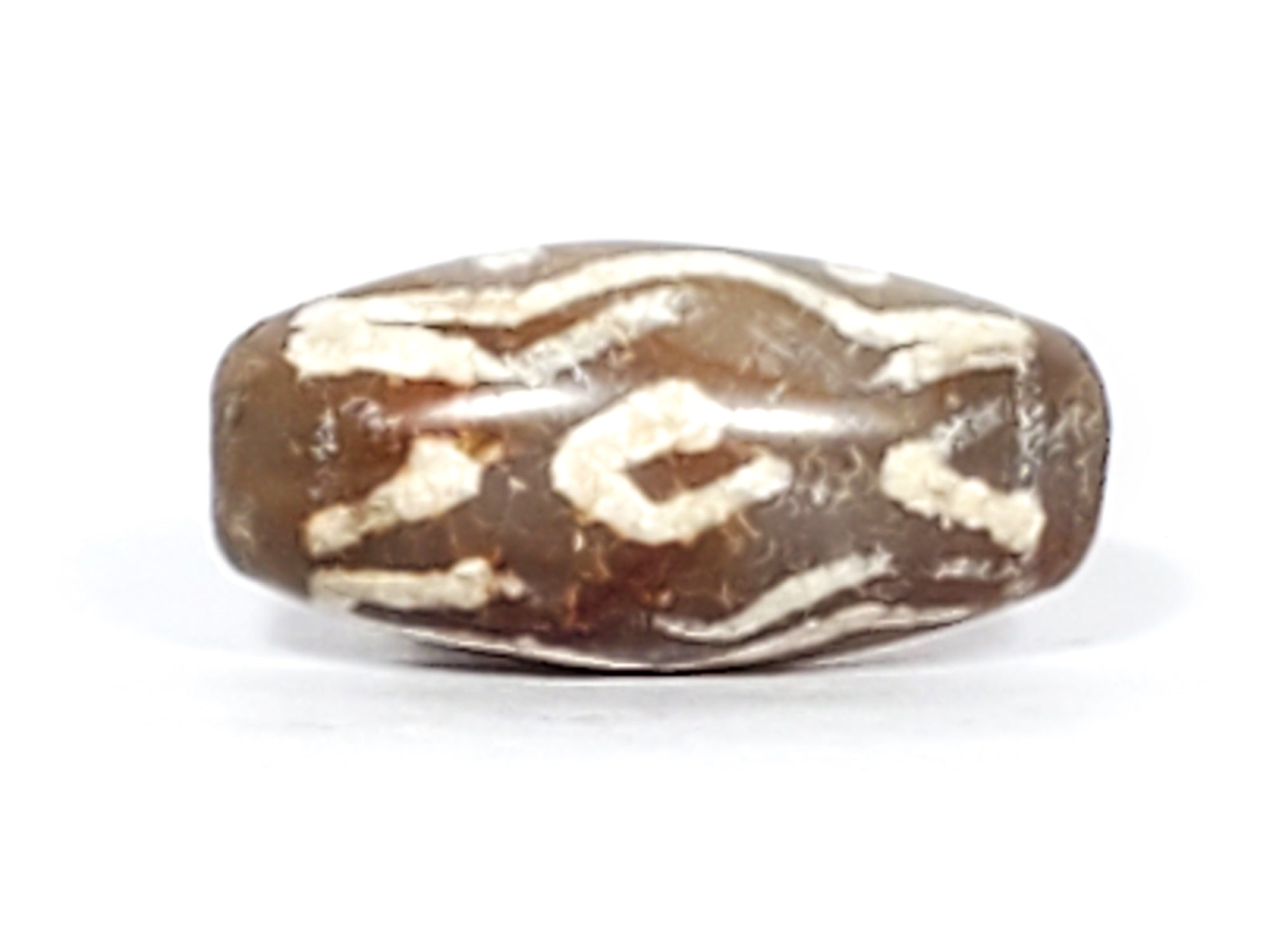 beautiful small ancient dzi bead adorned with the two eye, tiger tooth, stars, and wave motif.  