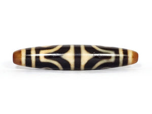 ancient Dzi bead adorned with a powerful Four Eye & Tiger Tooth motif. This bead carries deep spiritual symbolism, representing enhanced perception, inner strength, and protection. The Four Eye motif symbolizes heightened spiritual vision, while the Tiger Tooth motif embodies courage and warding off negative energies