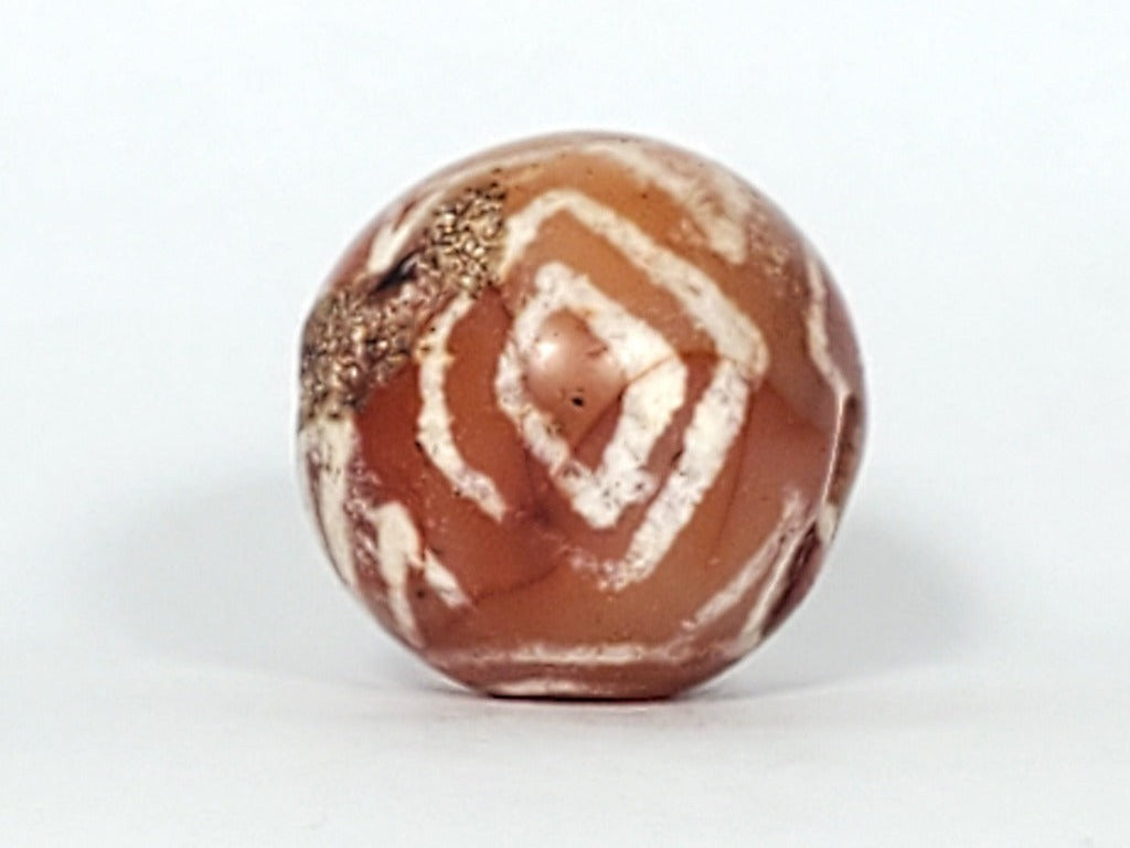 Authentic Ancient Round Diamond Eye-In-Eye & Tiger Tooth Motif Carnelian Dzi Bead (CD-DEIETT-R1). An authentic and ancient round Dzi bead adorned with the captivating Diamond Eye-In-Eye and Tiger Tooth motifs.