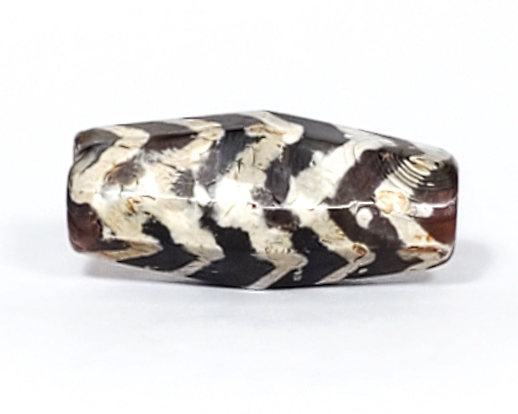  Ancient Dzi Bead - Five Tiger Stripe Motif Carnelian with Calcification. A highly collectible ancient Dzi bead carved from Carnelian, showcasing an intricate Five Tiger Stripe motif. The bead presents intriguing calcification patterns, making it a unique and sought-after piece among collectors. The Five Tiger Stripe motif carries ancient symbolism associated with strength, bravery, and protection