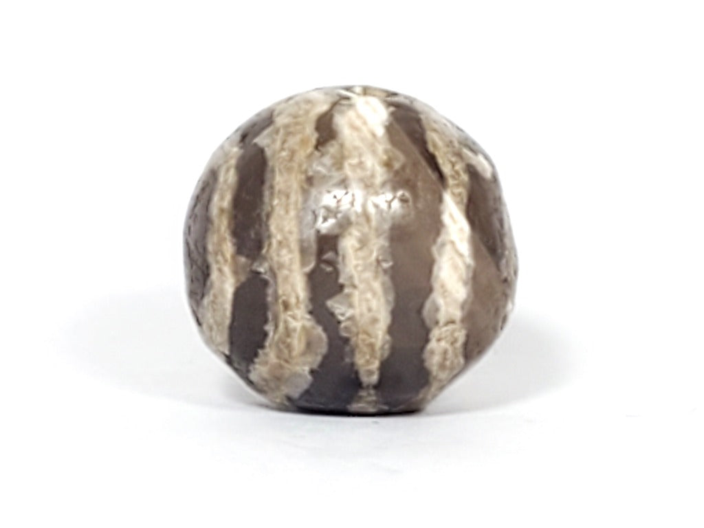 Ancient Dzi Bead - Five Stripe Motif. An authentic ancient Dzi bead featuring an intricate Five Stripe motif, representing a connection to ancient traditions and cultural heritage. This bead holds spiritual significance and is admired for its craftsmanship and historical value."