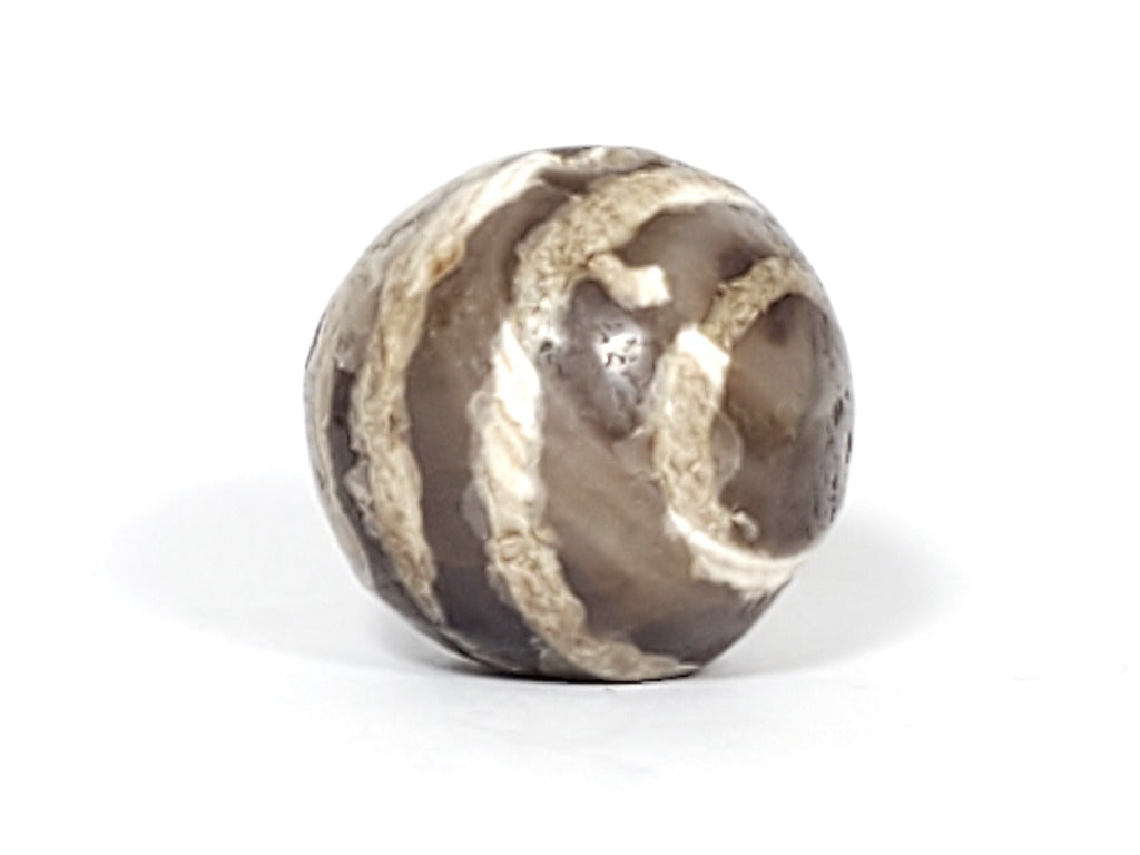 Ancient Dzi Bead - Five Stripe Motif. An authentic ancient Dzi bead featuring an intricate Five Stripe motif, representing a connection to ancient traditions and cultural heritage. This bead holds spiritual significance and is admired for its craftsmanship and historical value."