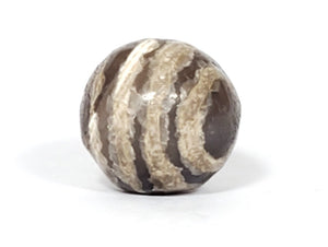 Ancient Dzi Bead - Five Stripe Motif. An authentic ancient Dzi bead featuring an intricate Five Stripe motif, representing a connection to ancient traditions and cultural heritage. This bead holds spiritual significance and is admired for its craftsmanship and historical value."