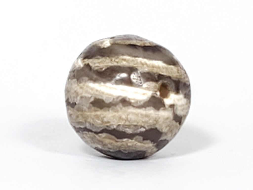 Ancient Dzi Bead - Five Stripe Motif. An authentic ancient Dzi bead featuring an intricate Five Stripe motif, representing a connection to ancient traditions and cultural heritage. This bead holds spiritual significance and is admired for its craftsmanship and historical value."