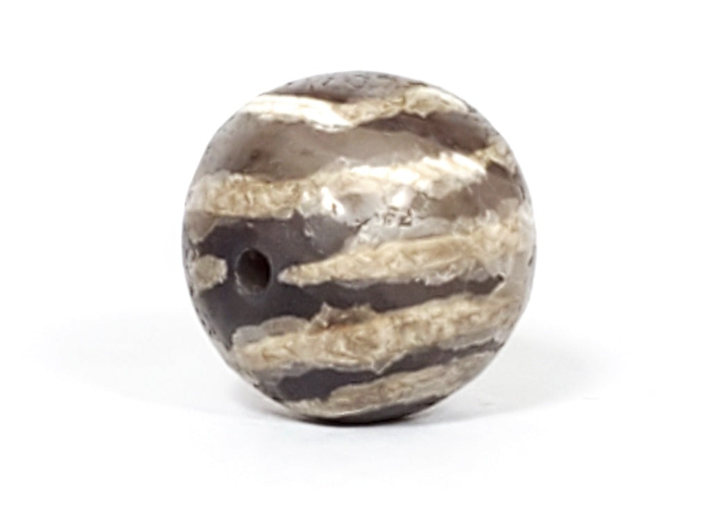 Ancient Dzi Bead - Five Stripe Motif. An authentic ancient Dzi bead featuring an intricate Five Stripe motif, representing a connection to ancient traditions and cultural heritage. This bead holds spiritual significance and is admired for its craftsmanship and historical value."