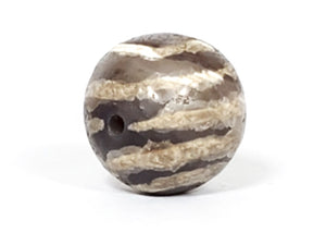 Ancient Dzi Bead - Five Stripe Motif. An authentic ancient Dzi bead featuring an intricate Five Stripe motif, representing a connection to ancient traditions and cultural heritage. This bead holds spiritual significance and is admired for its craftsmanship and historical value."