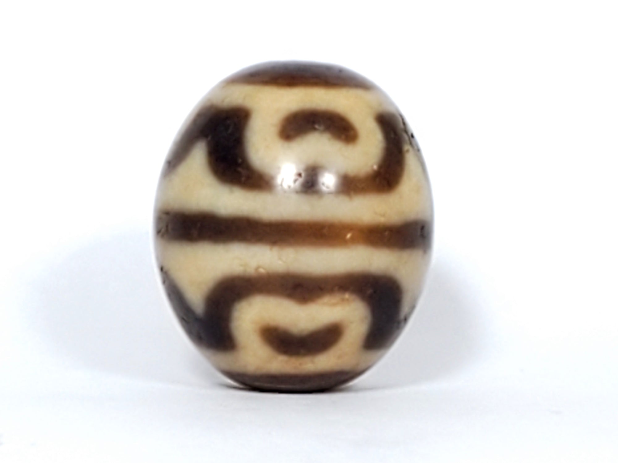 antique dzi bead featuring tiger tooth & lotus motif