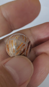 Ancient Round Double Diamond Eye-In-Eye Motif Carnelian Dzi Bead. An ancient round Dzi bead featuring a distinctive Double Diamond Eye-In-Eye motif. This Carnelian Dzi bead holds immense historical and cultural value, reflecting the meticulous craftsmanship of Tibetan artisans