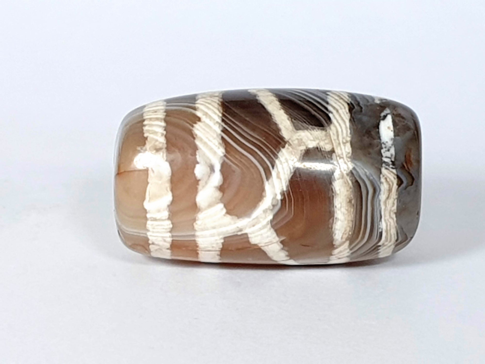 beautiful antique dzi bead with longevity motif.  the natural stone patina shows through beautifully