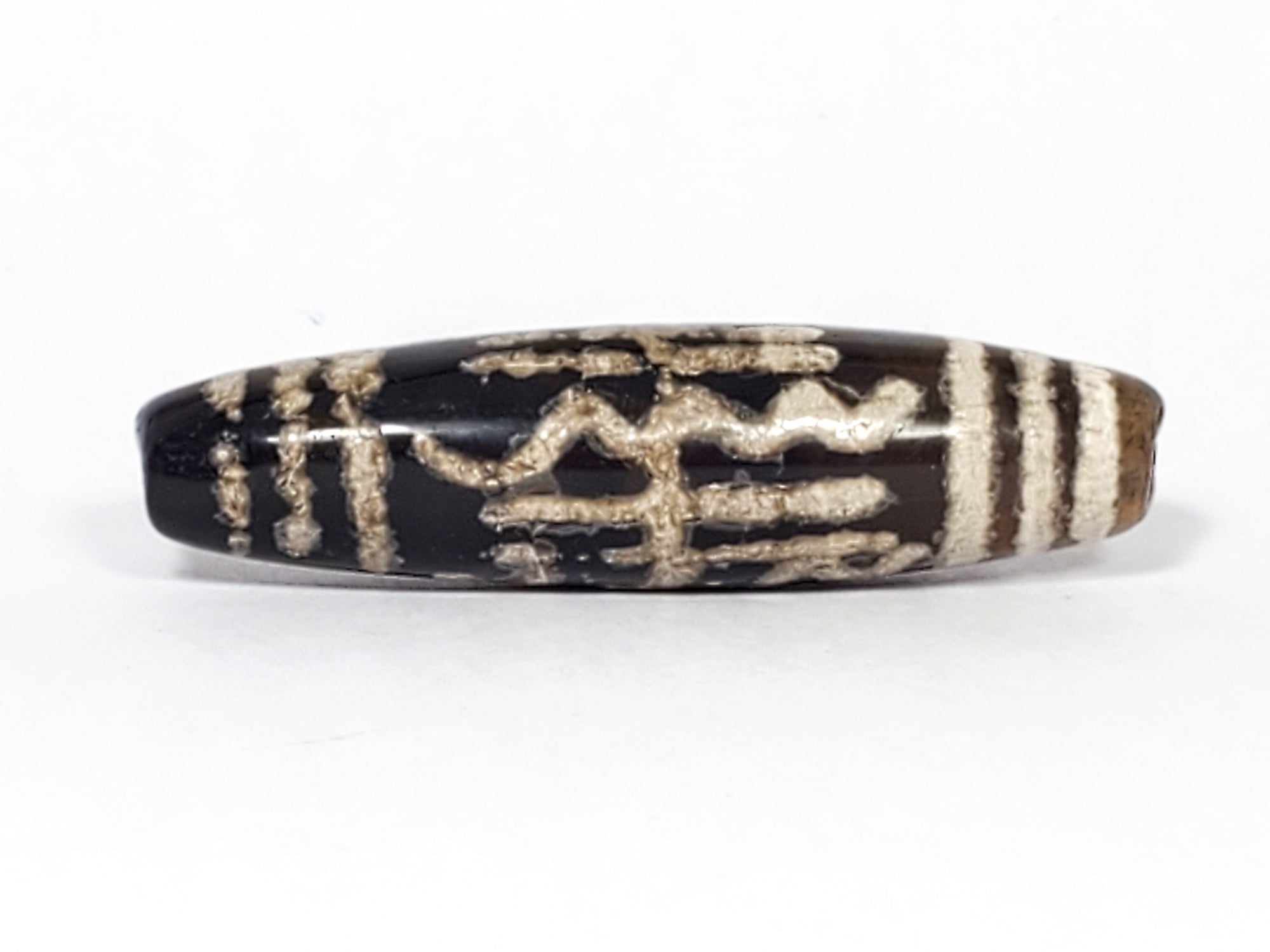 antique dzi bead from the Indus Valley.  It is adorned with the weave and bars pattern.